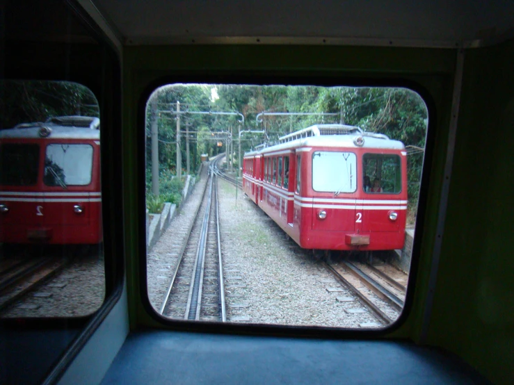 an orange train is driving down the tracks