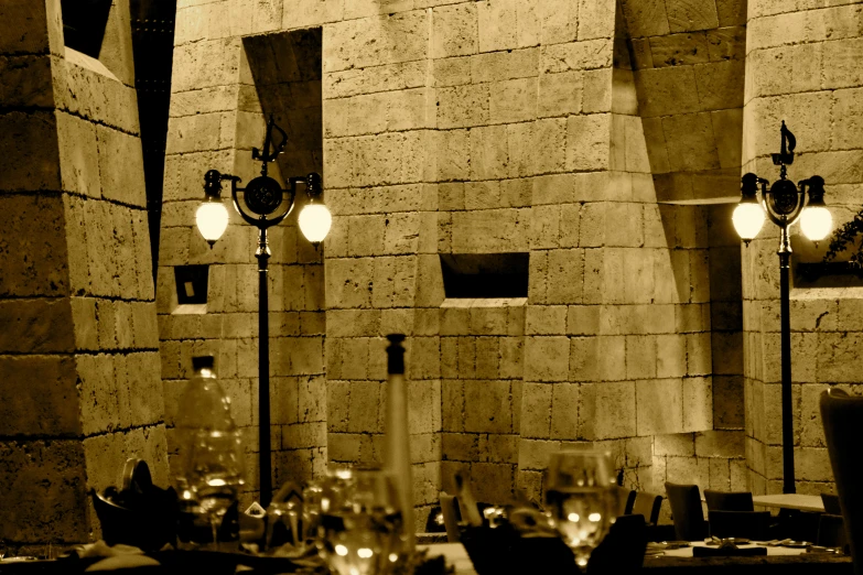 the dark image is taken of a dining room table with many glasses