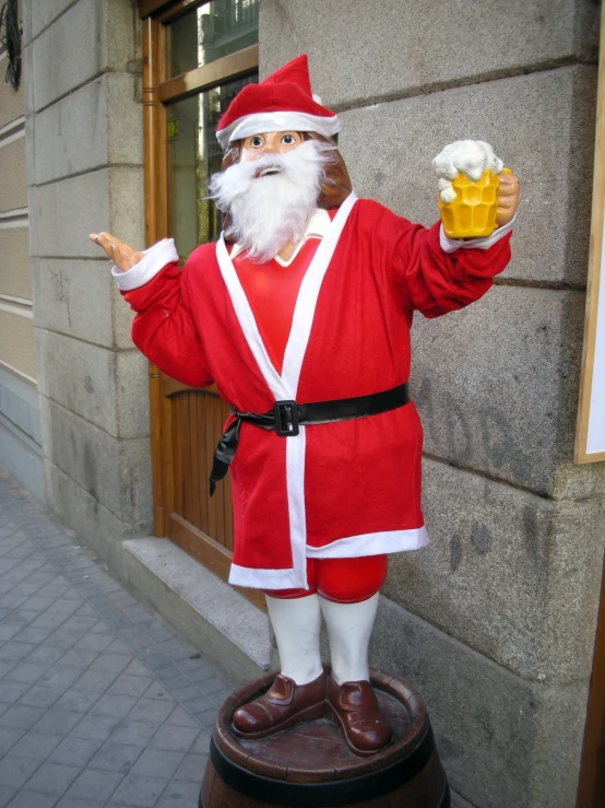 a statue of santa claus on a stone column