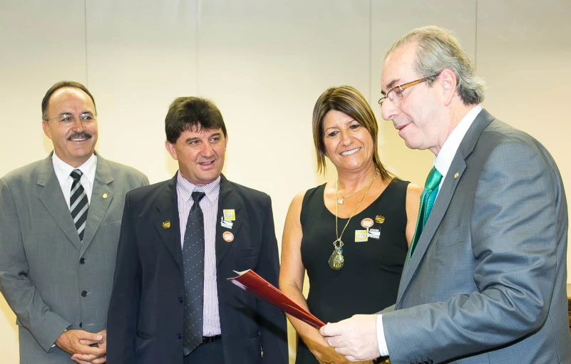 three business people are standing next to each other