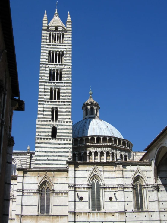 a large building with a white tower and a bell