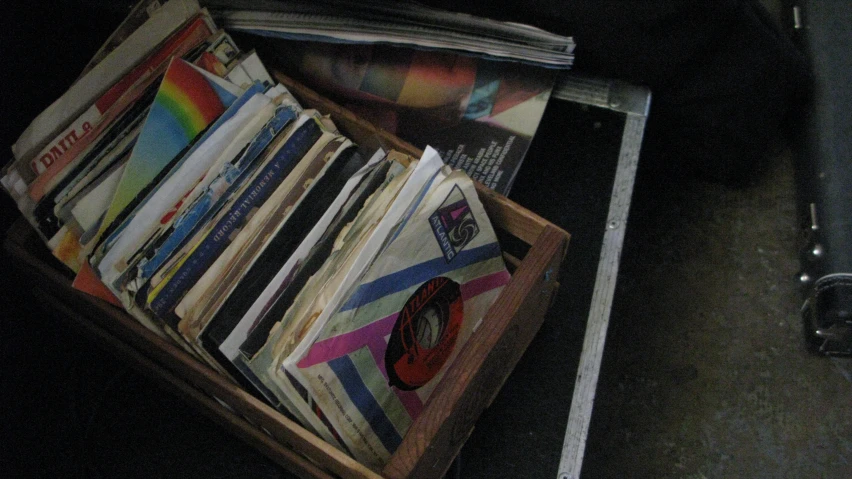 an empty box sitting on a table filled with magazines