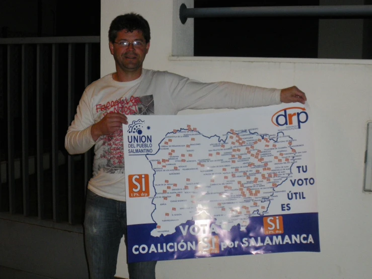 a man holding a map as he poses for a po