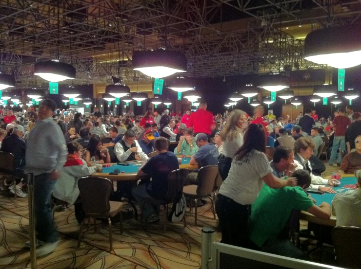 a large group of people sitting around tables in a stadium