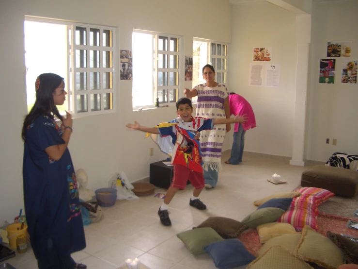 some people in a room and one is holding a frisbee