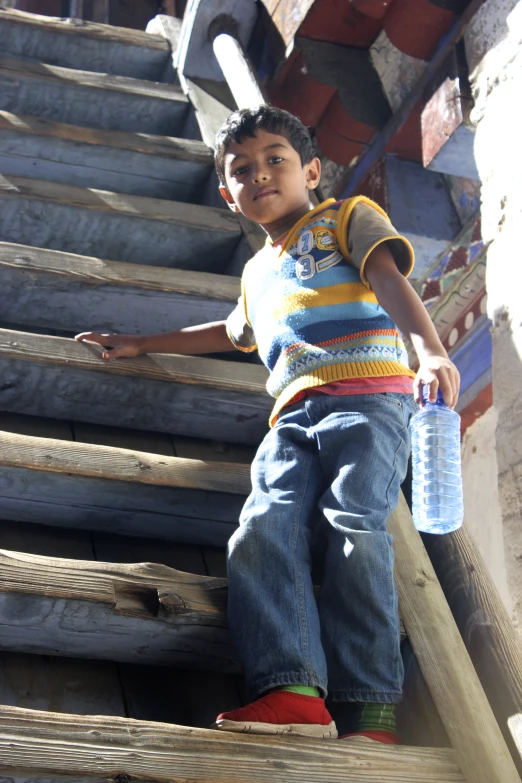  with plastic bottle on steps leading up to a house