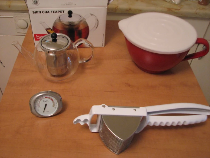 kitchen utensils and containers on wooden counter in room