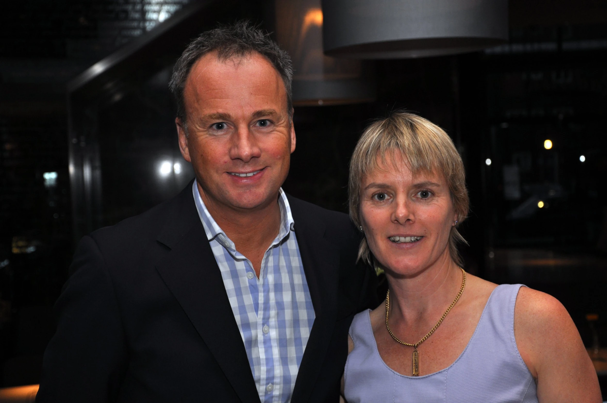 a man and a woman in blue dress standing side by side