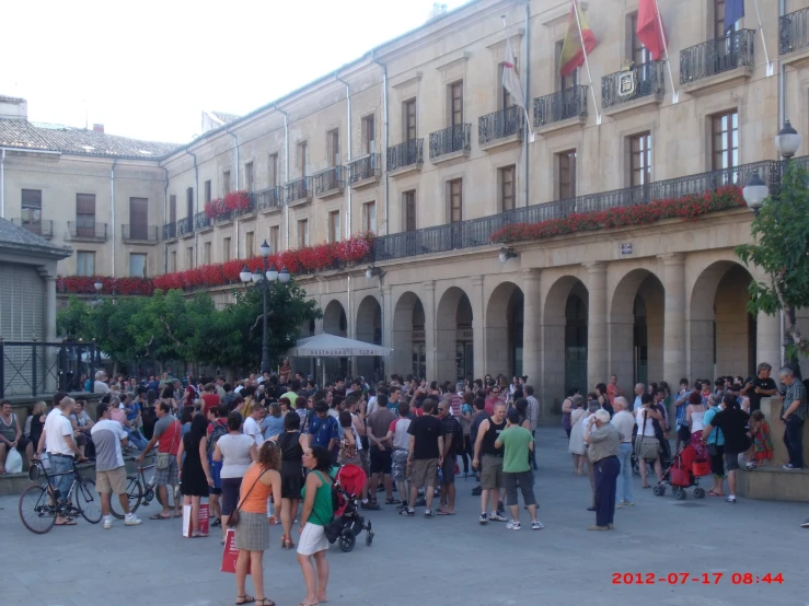 a crowd is gathered in front of a building