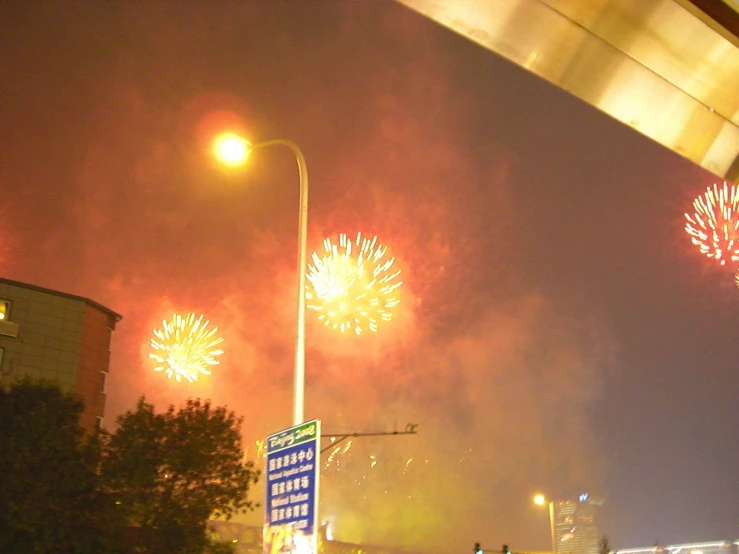fireworks explode on the city street in the night