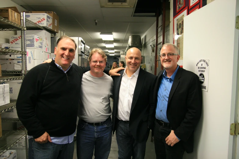 three men are posing next to each other