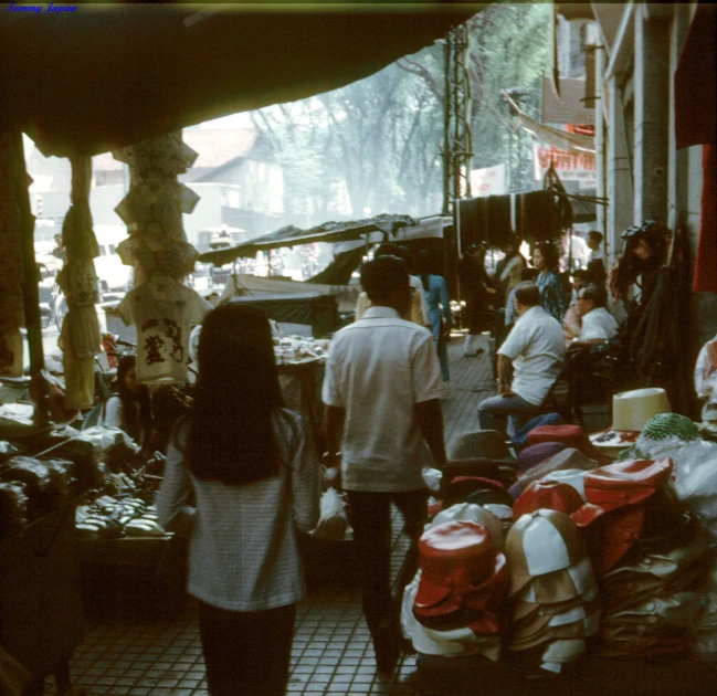 people shop for items in a small outdoor market