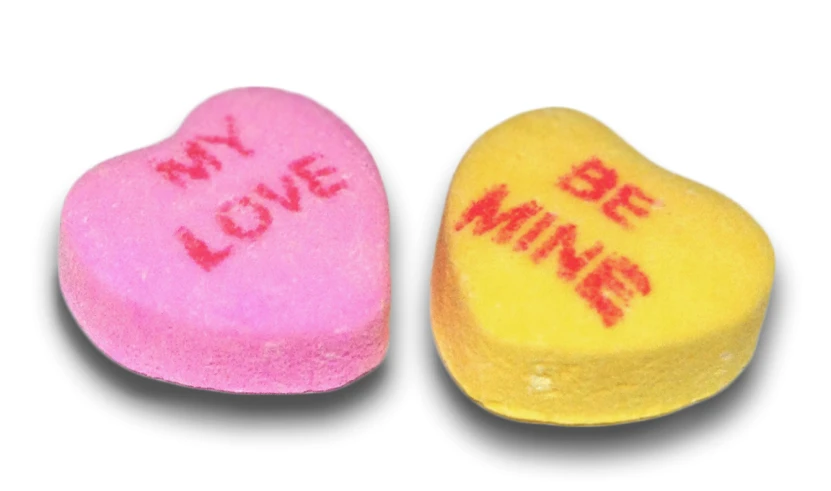 two conversation rocks with candy written on them