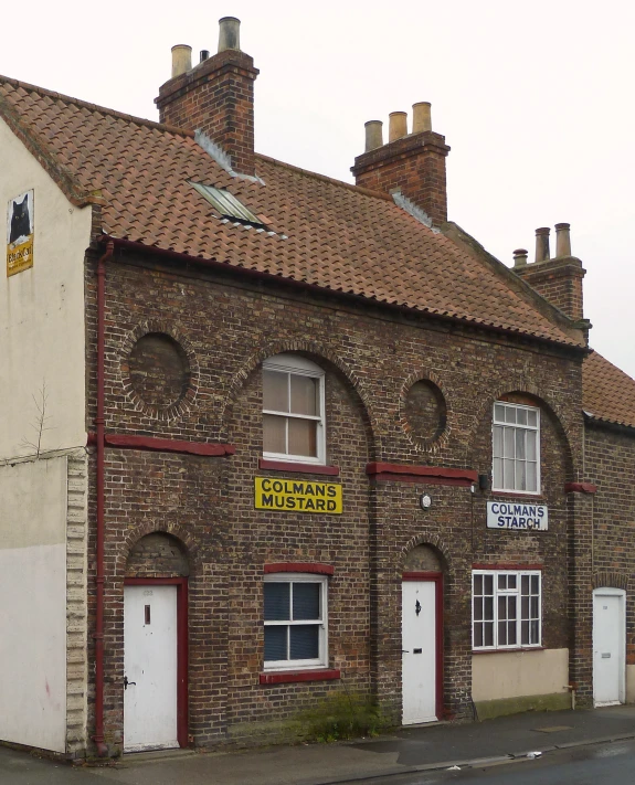 an old brick building on a street corner