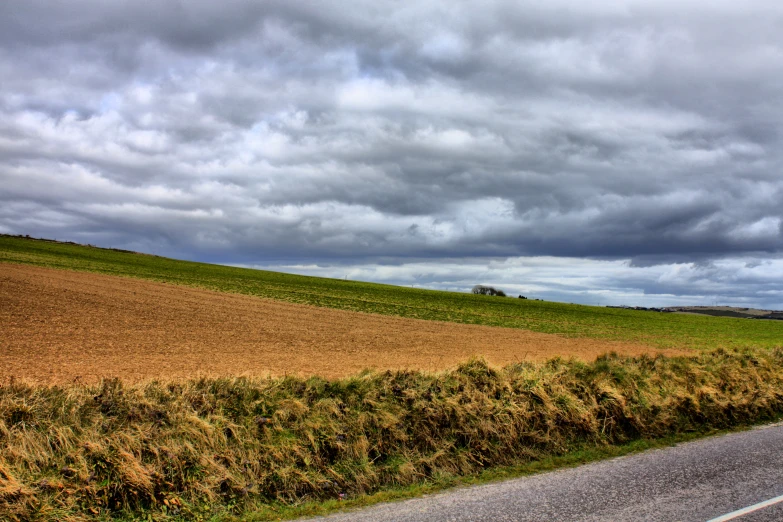 a country road passing by some fields