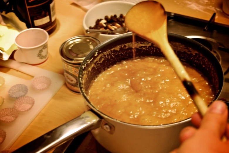 a pot full of food that is being stirred by a ladle