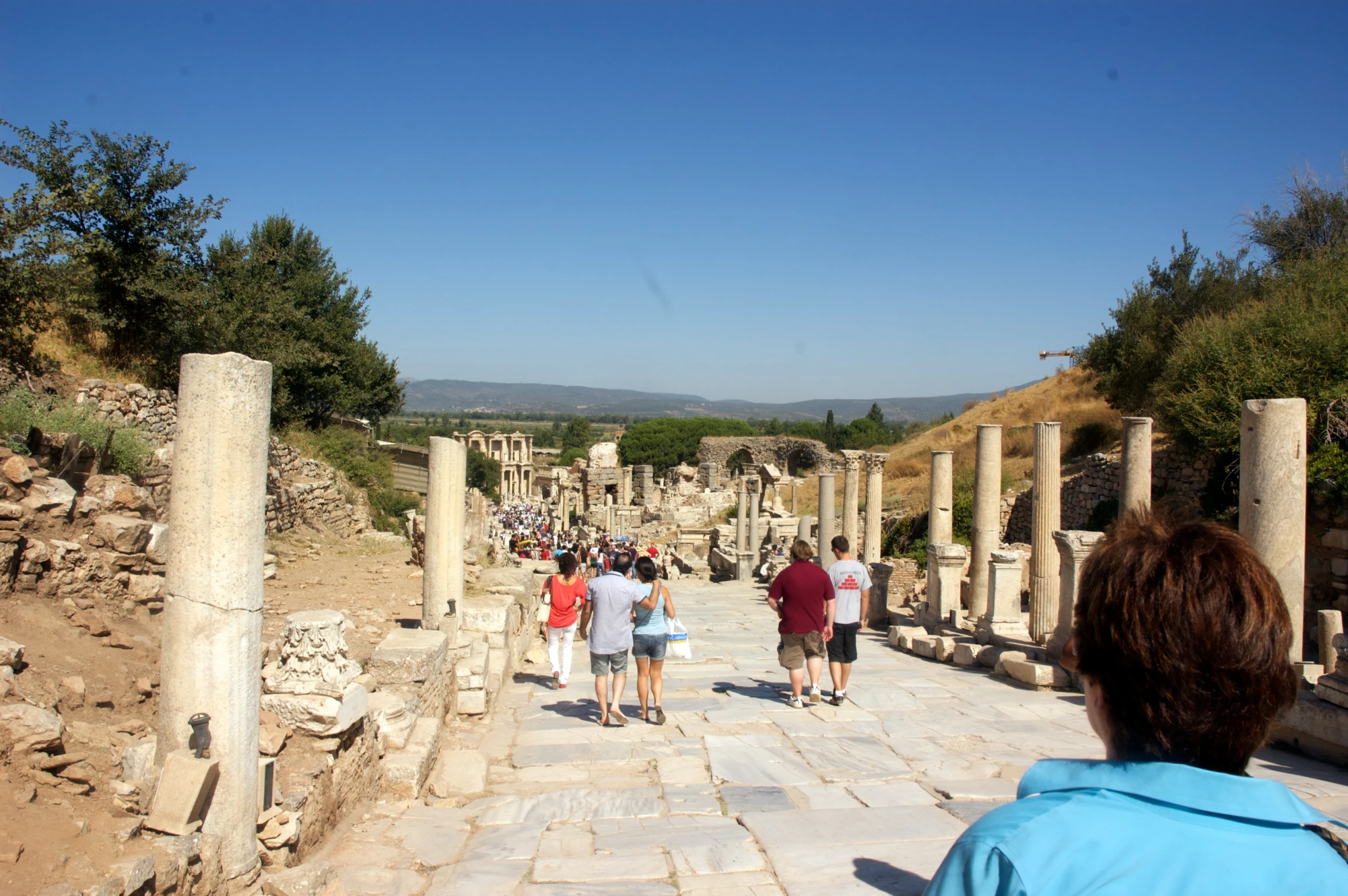 a group of people walking in a roman ruins