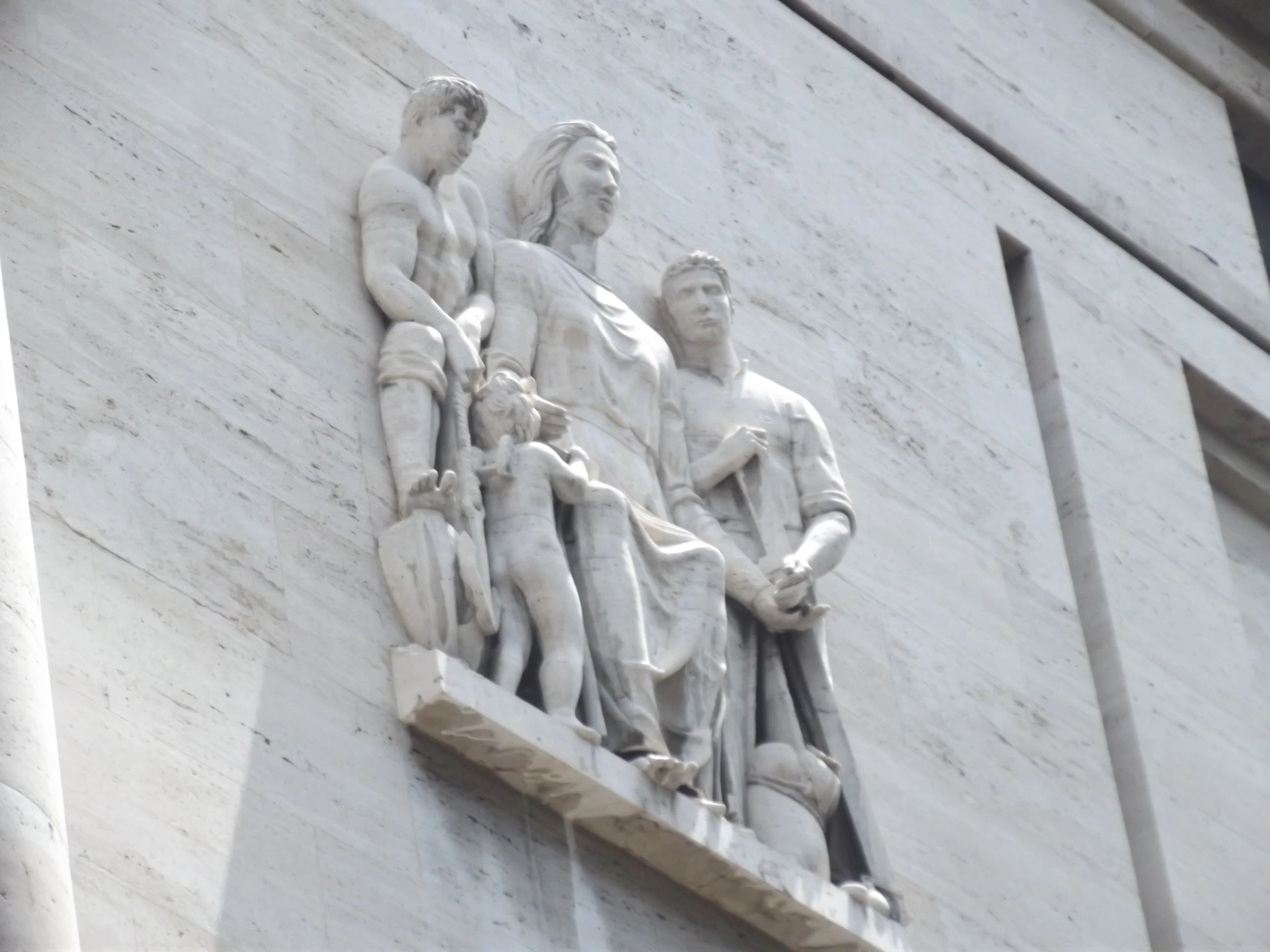this is an image of some statues on the side of a building