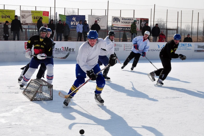 a group of people playing hockey in a field