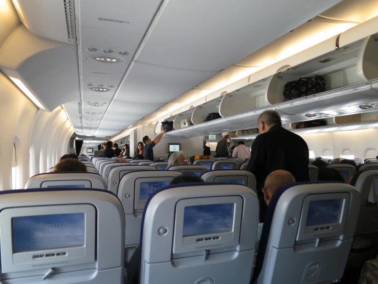 a man standing on an airplane in the aisle