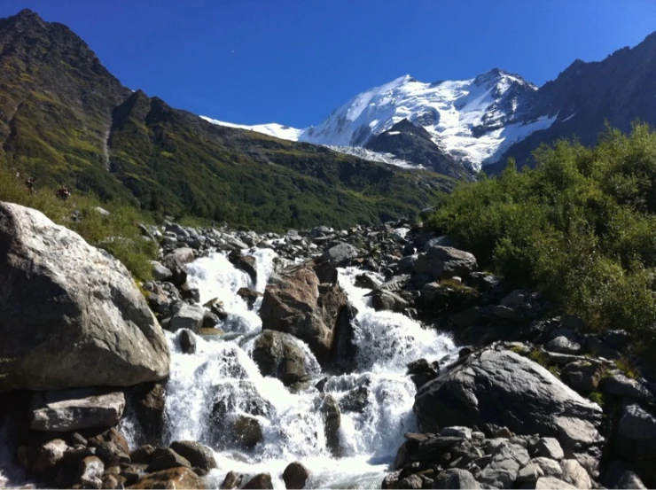 a mountain stream surrounded by rocks and mountains