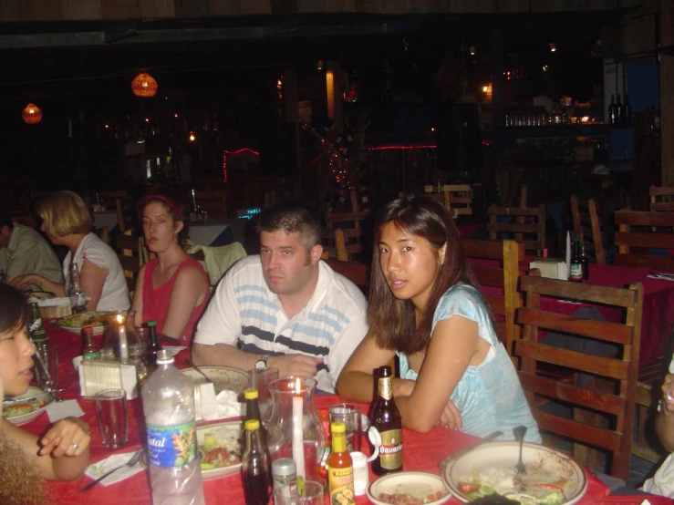 a group of people sit in a restaurant together