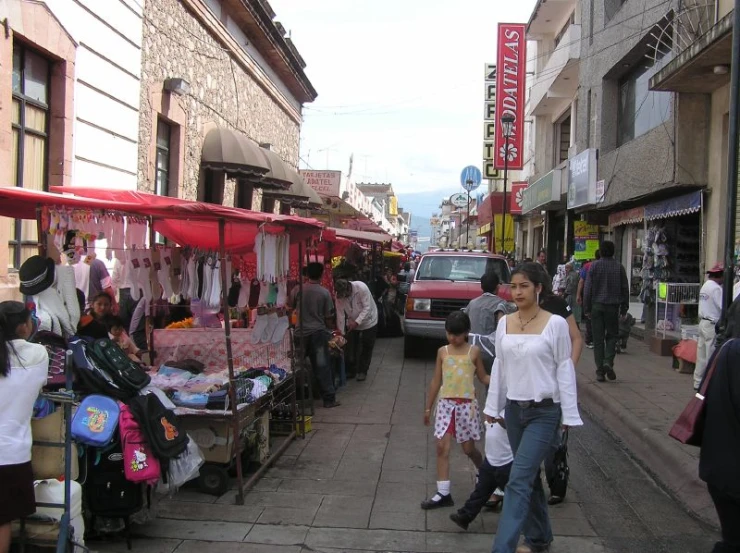 a market is shown with people walking around