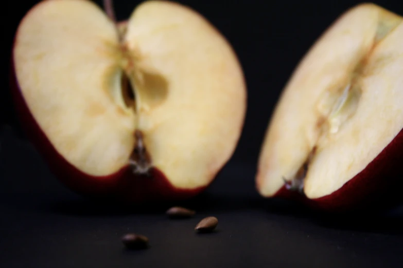 a split apple that is on the table