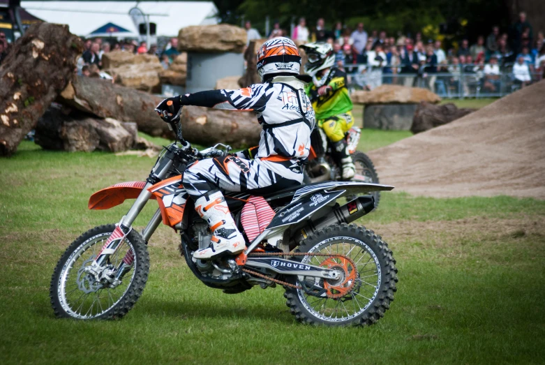 a guy riding on the back of a dirt bike