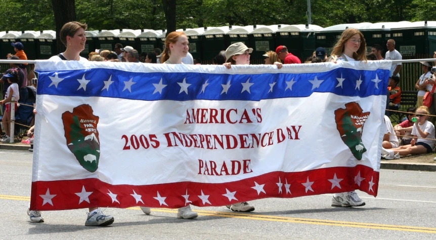 a large american flag for the presidents of the united states is carried by two children