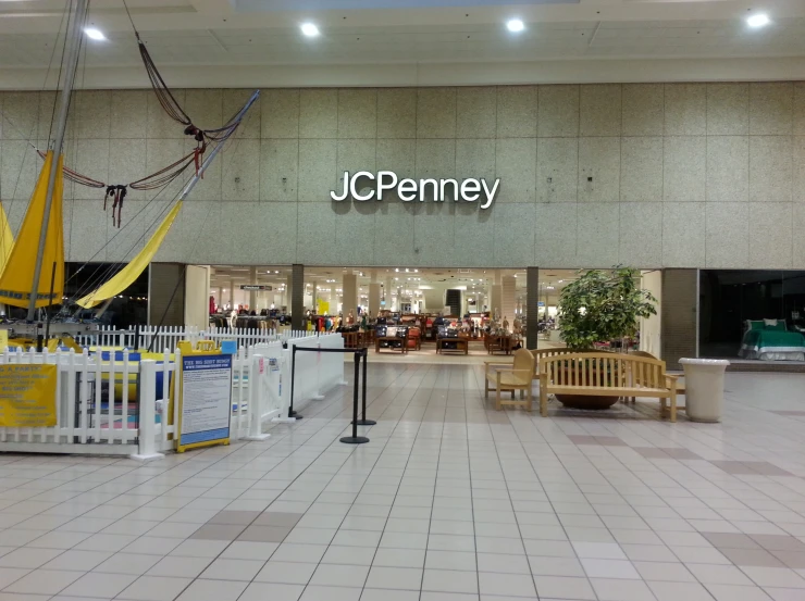 the entrance to jc penney, with benches on the floor