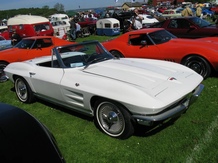 several cars are parked together on the grass