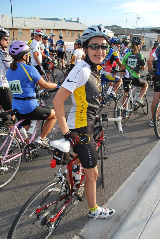 a woman is standing next to a group of bicycles