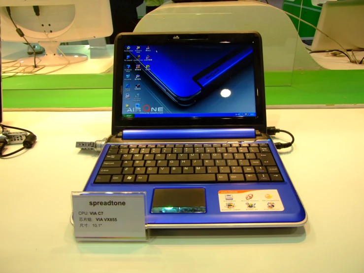 a laptop sitting on a table with an id slot