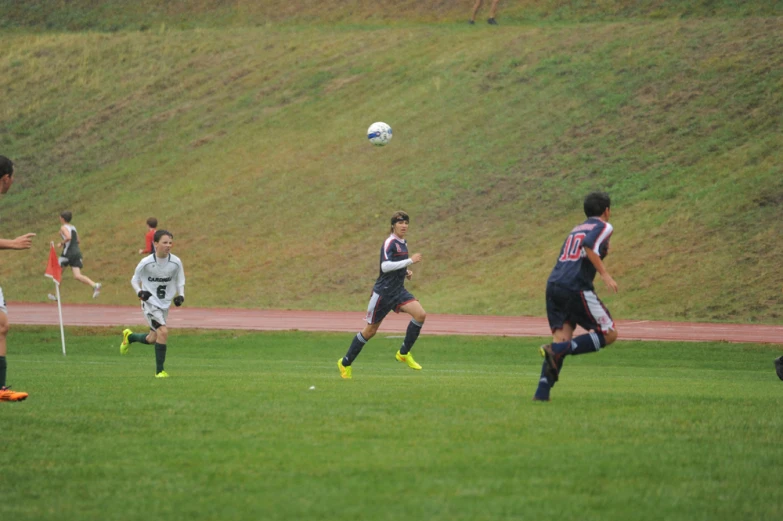 a soccer game in progress with players competing for the ball