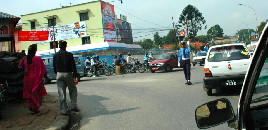 a man in a blue shirt and some people on bikes