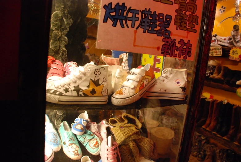 a display of various shoes with characters on them