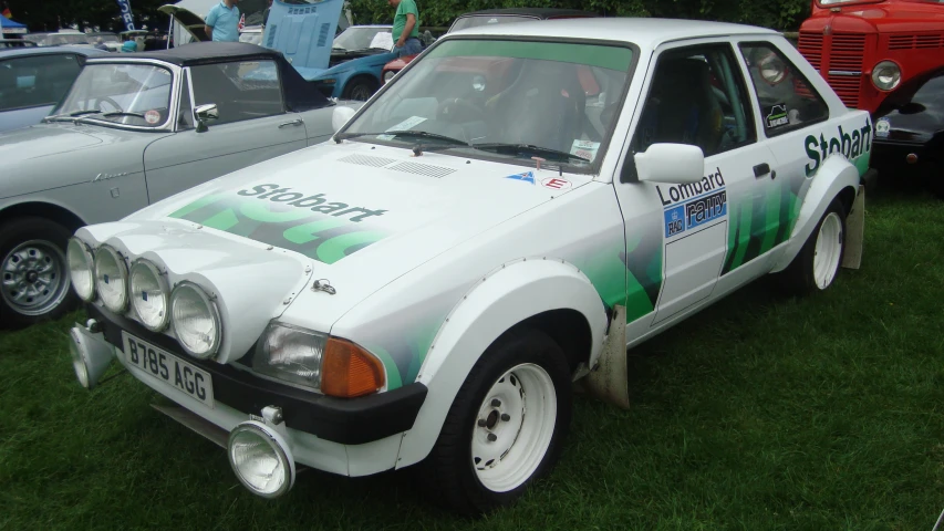 some cars are parked in a grass field