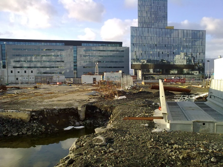 a construction site with buildings next to a body of water