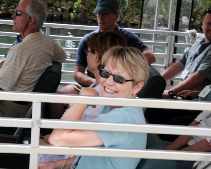 woman with sunglasses on smiling on boat