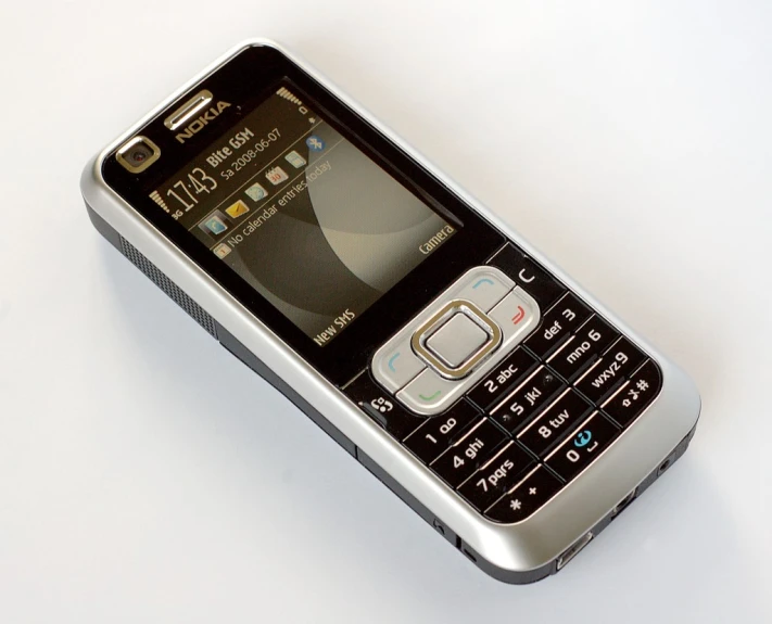 a cell phone sitting on top of a white surface