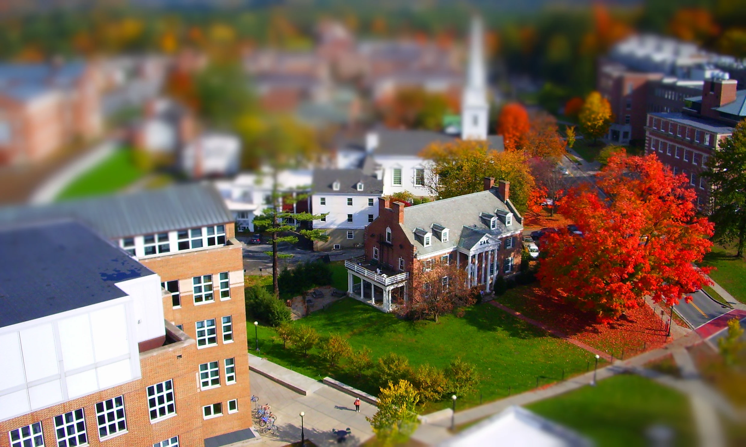 a large town and small church with trees turning orange