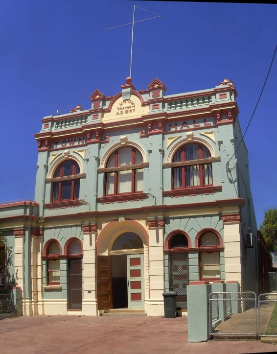 an old building is being restored with a red and blue roof