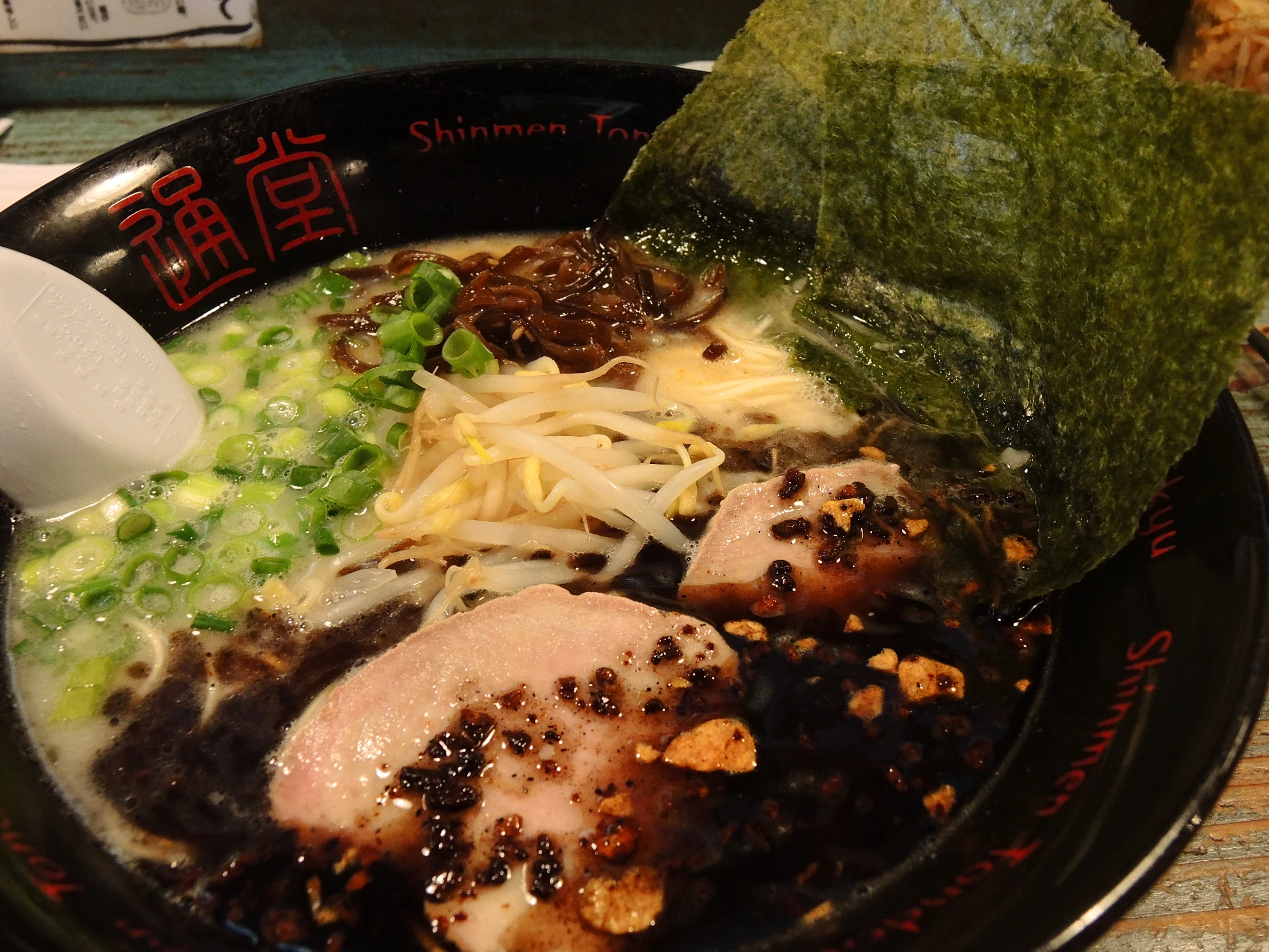 the bowl is filled with ramen and vegetables