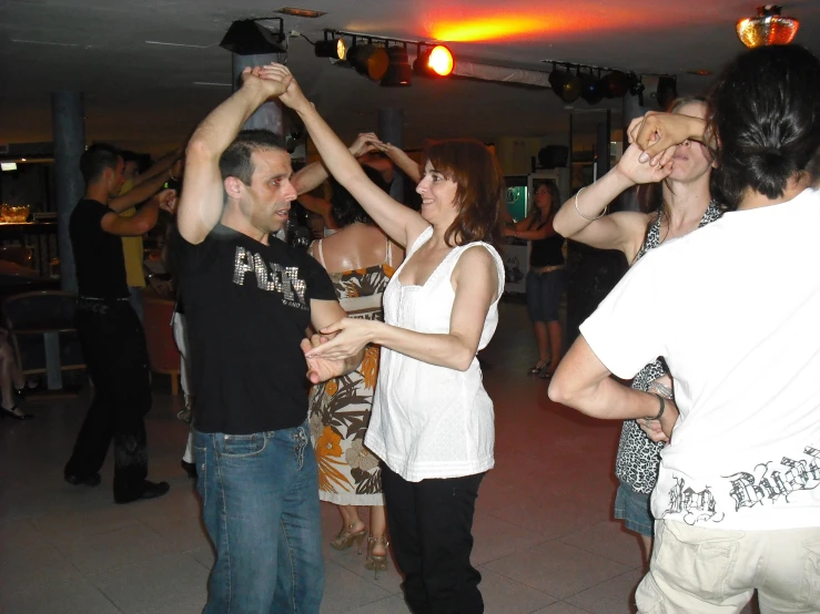 a crowd of people dancing at an event
