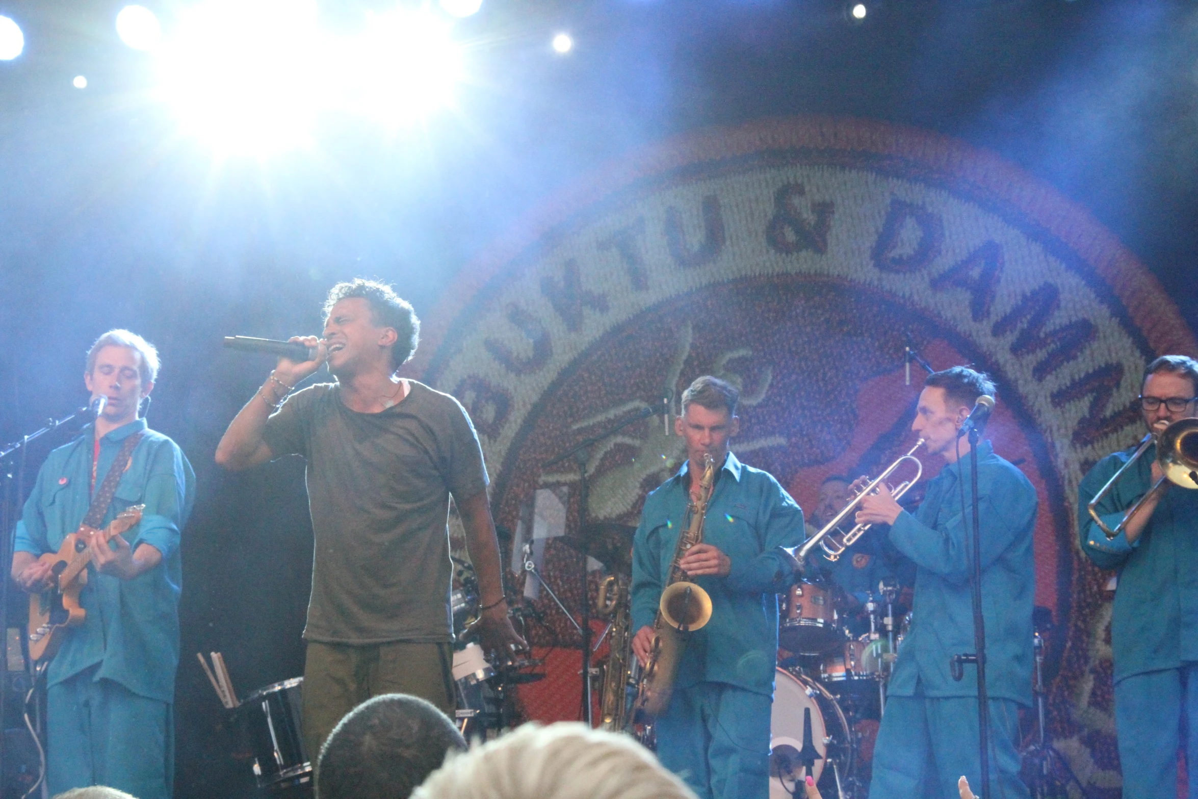 a band playing on stage while people watch