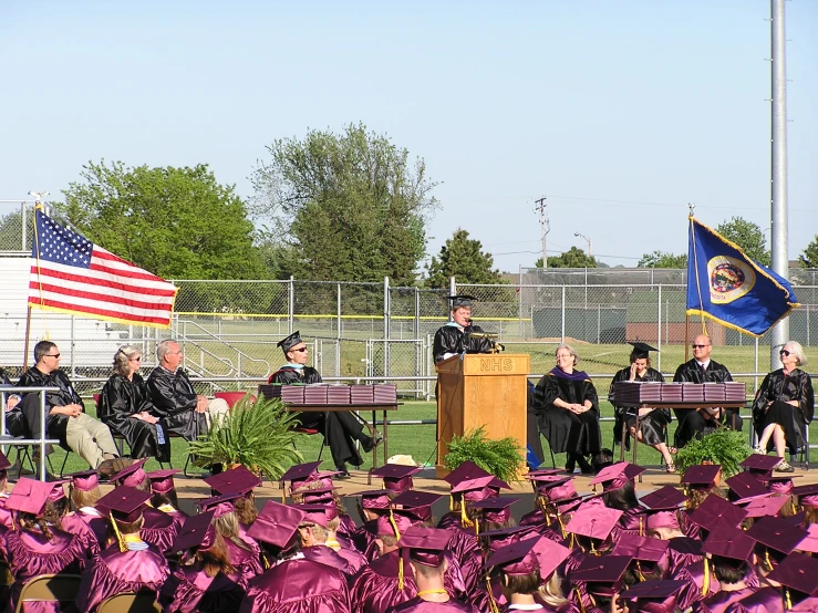 a graduation ceremony is taking place at the park