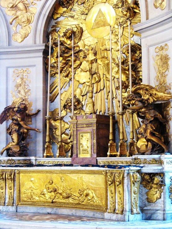 golden sculpture set within a grand throne and on display