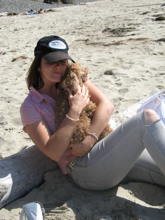 a girl lying on the beach wearing sunglasses