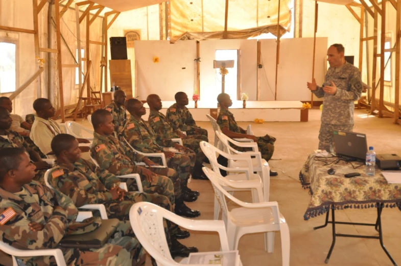a military man giving a speech to a crowd of soldiers